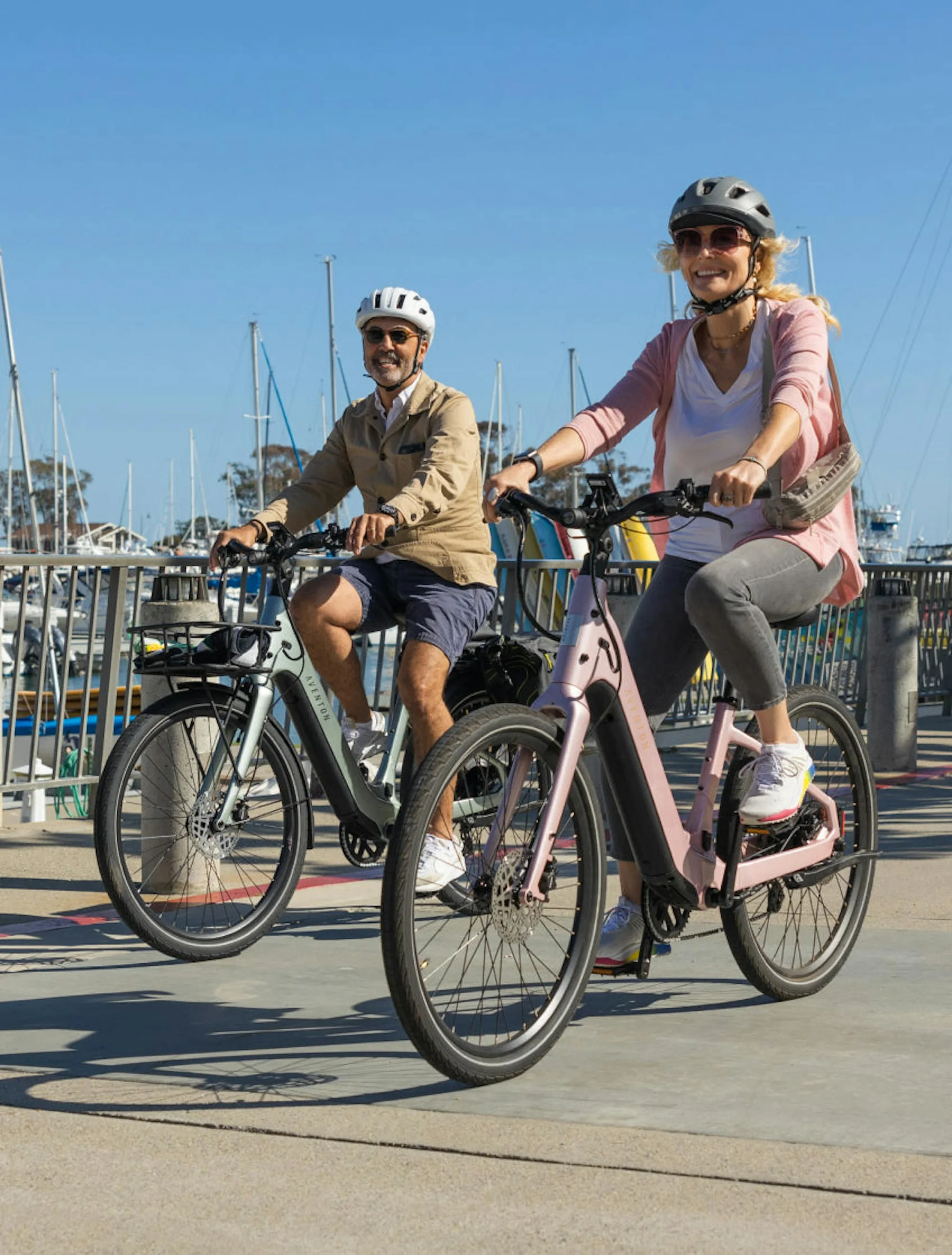 Two riders enjoying Aventon electric bikes by the marina